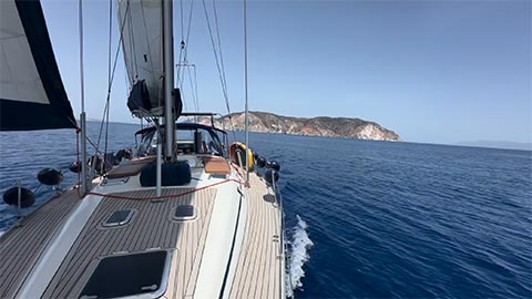 Sailing Greek islands autumn - Sailboat in secluded cove